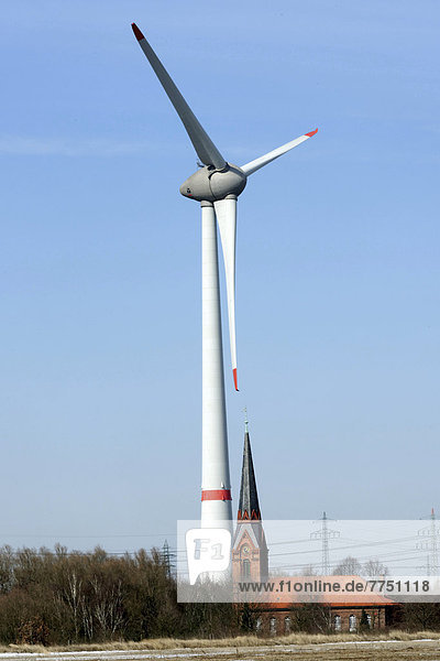 Wind turbine beside the old Church of St. Gertrud
