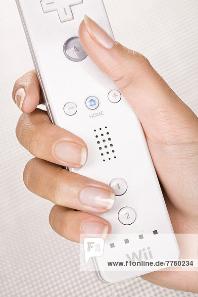 Woman's hand holding a wiimote