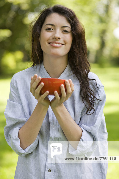 Portrait of young woman holding bowl