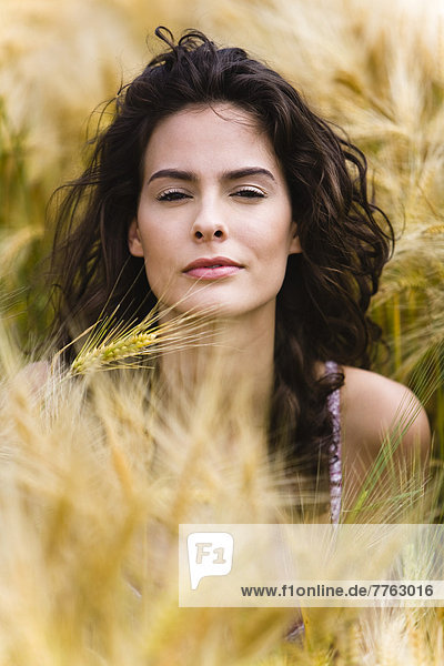 Portrait of young woman in wheat field