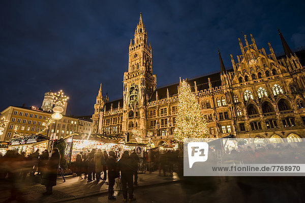 Christmas market at Marienplatz square with the town hall and a Christmas tree