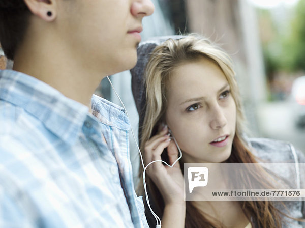 Teenagers listening to MP3 player