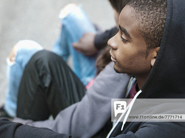 Teenagers sitting in the street