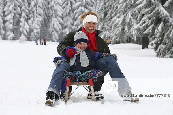 Mother and boy  four years  sledging