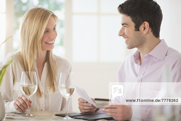 Couple in restaurant  man paying