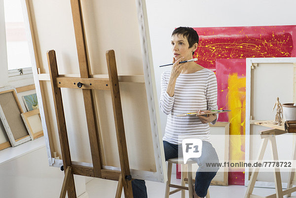 Female artist painting in her studio