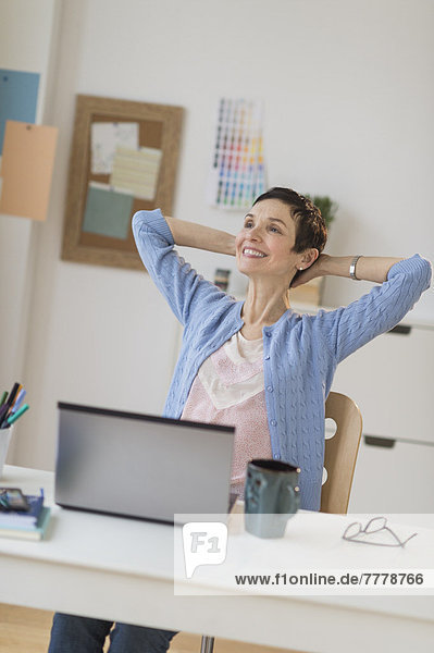 Woman relaxing in home office