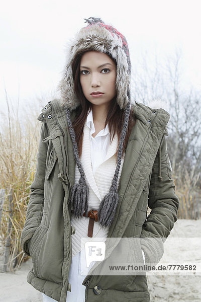 Portrait of young woman in warm clothes