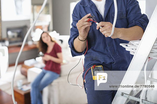 Electrician working in living room