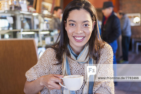 Mixed race woman sitting in coffee shop