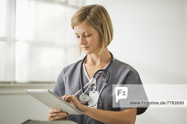 Caucasian nurse holding digital tablet