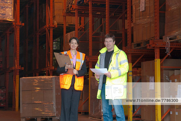 Female and male workers in warehouse