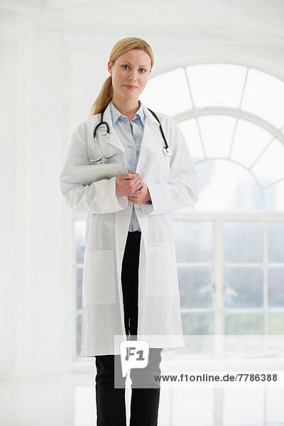 Portrait of female doctor with stethoscope and digital tablet