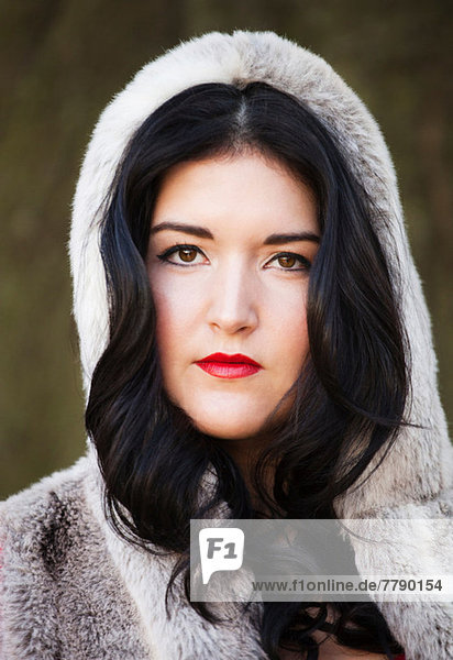 Young woman wearing fur hood