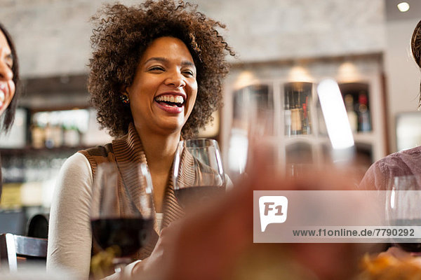 Woman at restaurant laughing