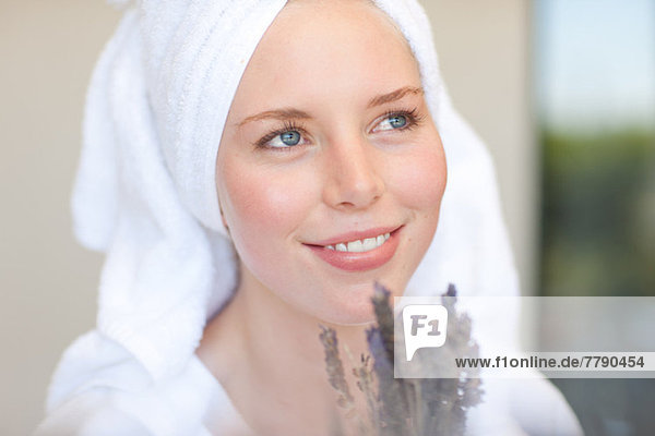 Young woman wearing towel on head with lavender