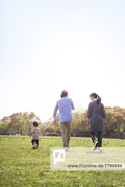 Japanese family walking a park