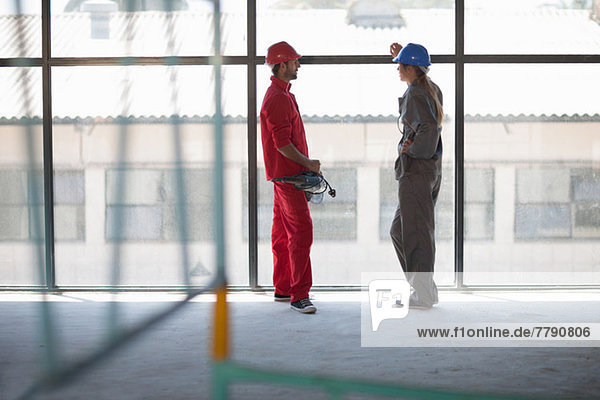 Laborers talking in front of window