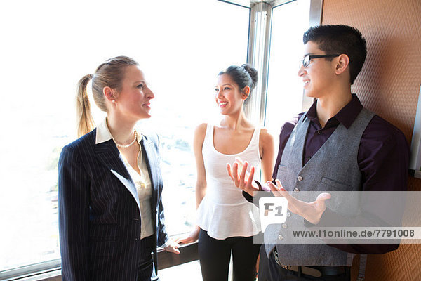 Three young businesspeople talking