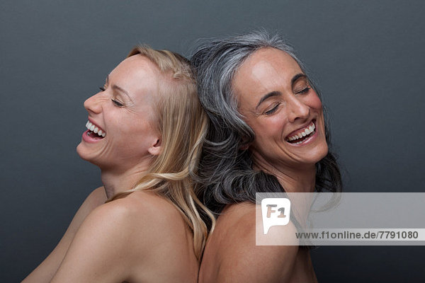 Young woman and mature woman laughing