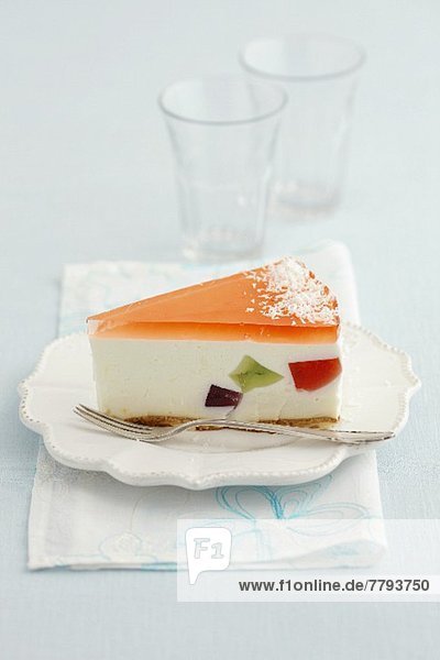 A slice of cheesecake with fruit jelly