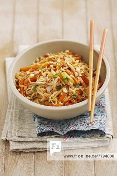 Spaghetti with carrots  spring onions and pine nuts