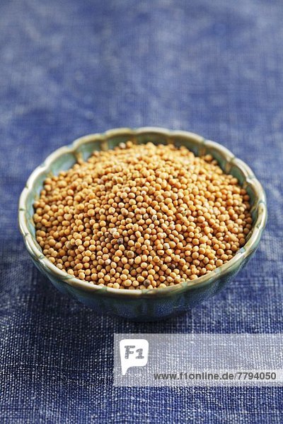 White mustard seeds in a small bowl