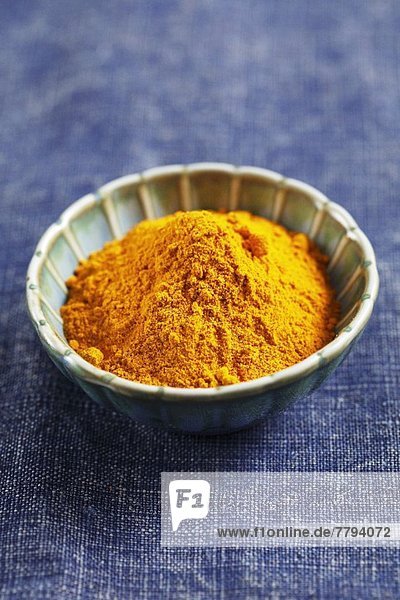 Ground turmeric in a small bowl