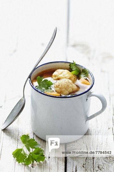 Vegetable soup in an enamel cup