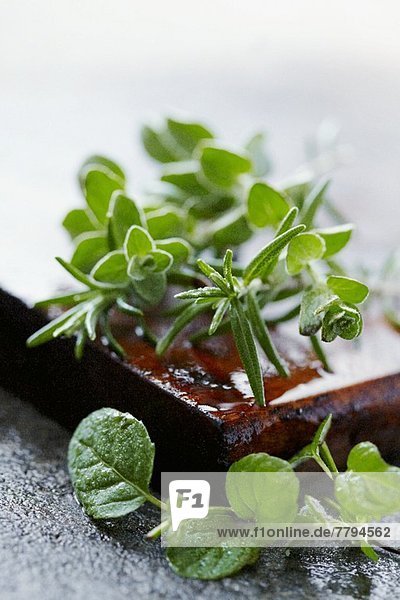 Rosemary and marjoram on a wooden board