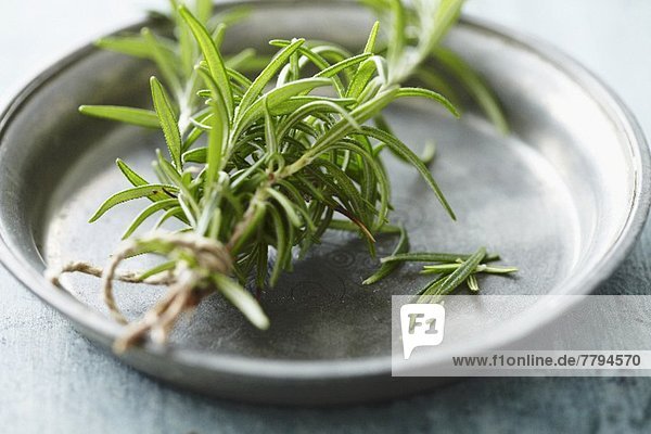 Rosemary sprigs on a tin plate
