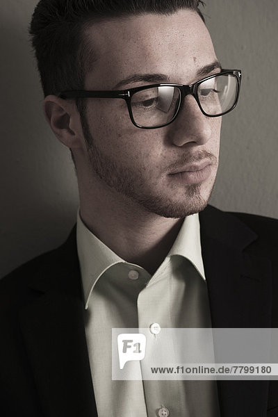 Head and Shoulder Portrait of Young Man wearing Glasses  Studio Shot