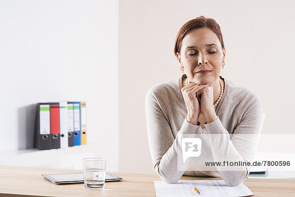 Mature Woman Thinking in Office