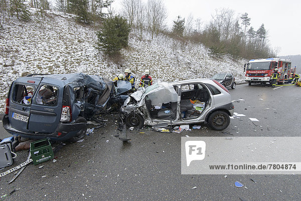Head-on collision of a Dacia Logan with an Opel Corsa  rescue workers at the accident site