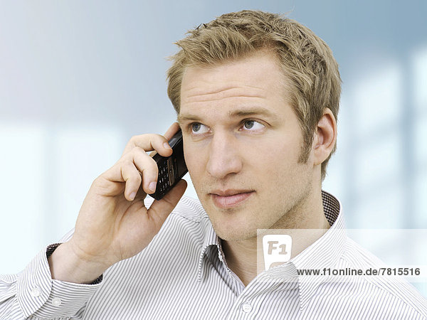 Businessman using a mobile phone  concentrating
