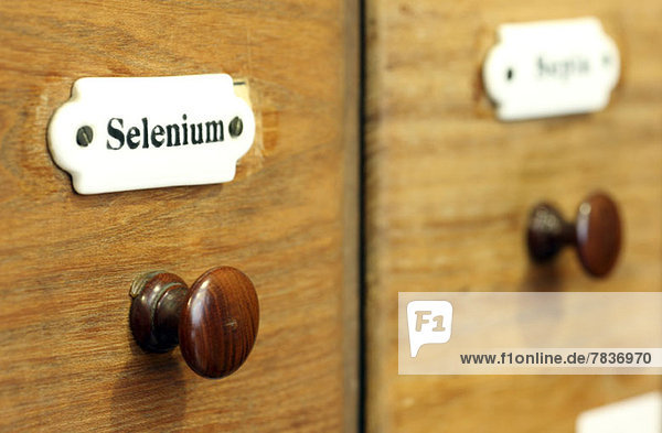 A wooden drawer in pharmacy containing the chemical element Selenium