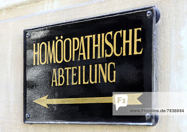 Metal plaque reading 'Homeopathic department' in German