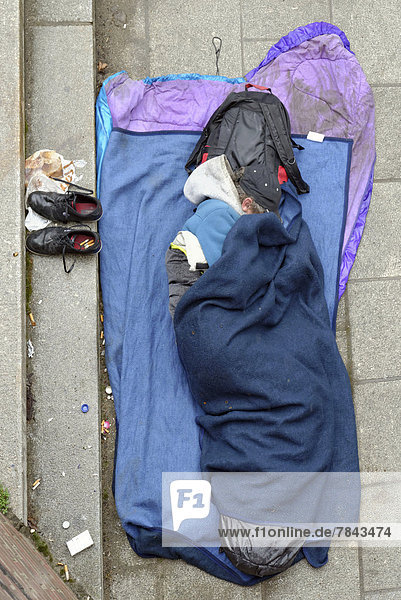 Homeless man sleeping on the ground