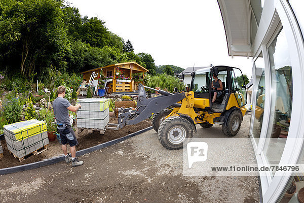 Germany  Rhineland Palatinate  Workers unloading paving stone