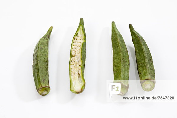 Okra beans on white background  close up
