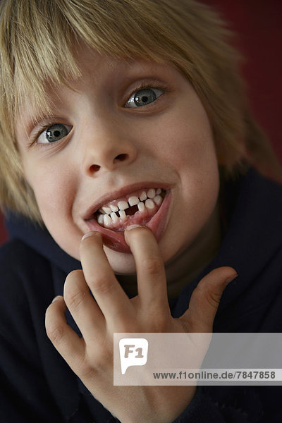 Austria  Boy showing tooth gap  close up