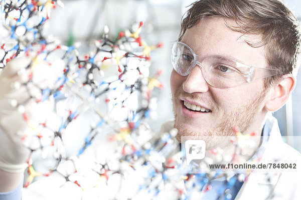 Germany  Young scientist with DNA model