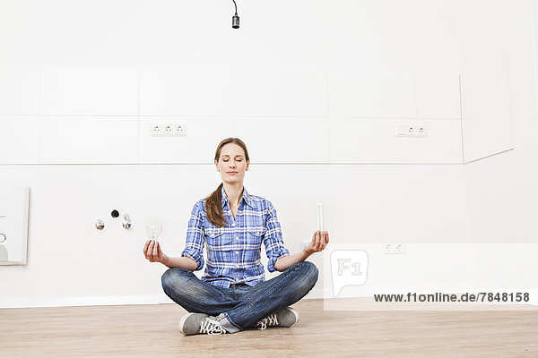 Woman sitting on floor with bulbs