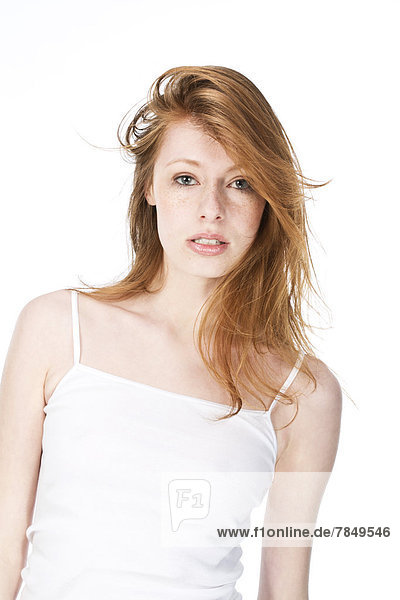 Portrait of young woman against white background  close up