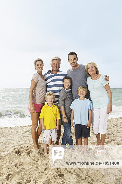 Spain  Portrait of family on beach at Palma de Mallorca  smiling