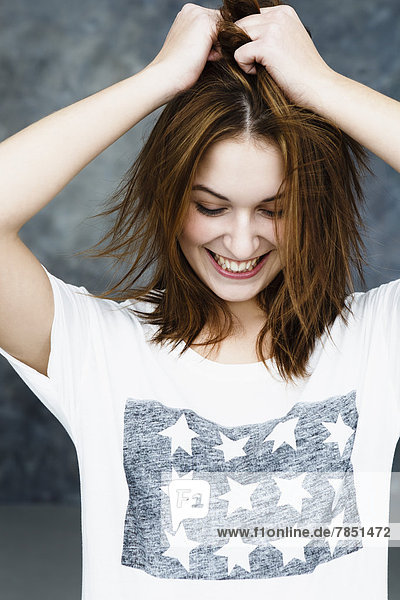 Young woman pulling her hair  smiling