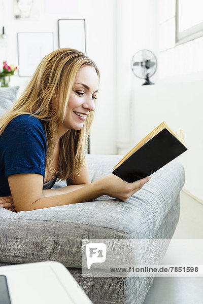 Young woman reading book  smiling