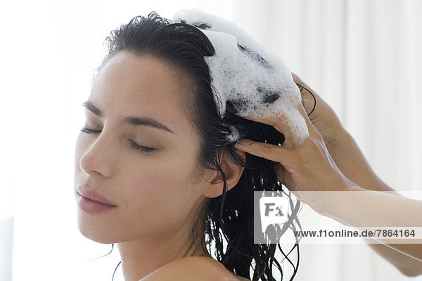Woman having her hair shampooed