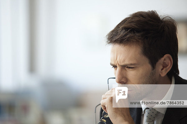 Businessman thinking with furrowed brow