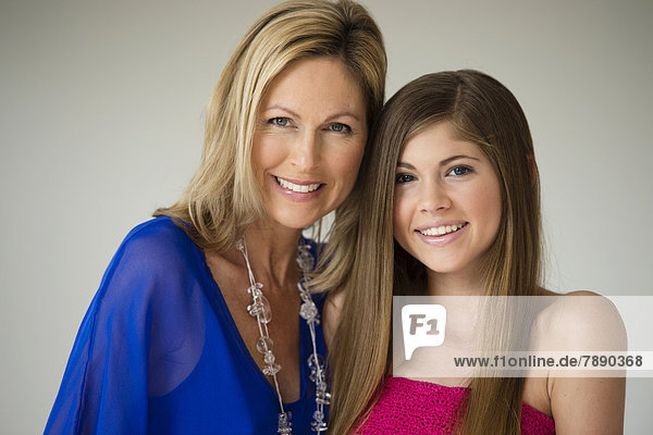 Caucasian mother and daughter smiling